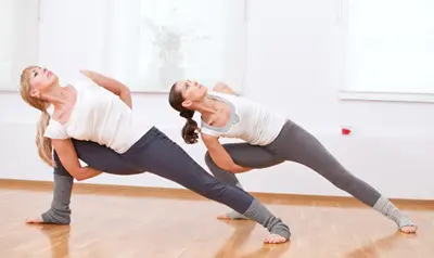Women practicing vinyasa yoga
