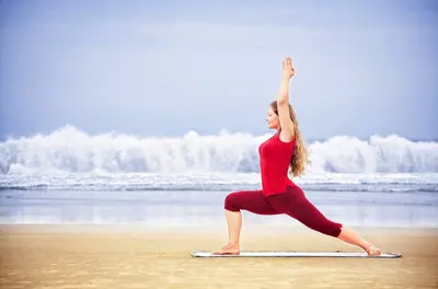 woman practicing warrior pose