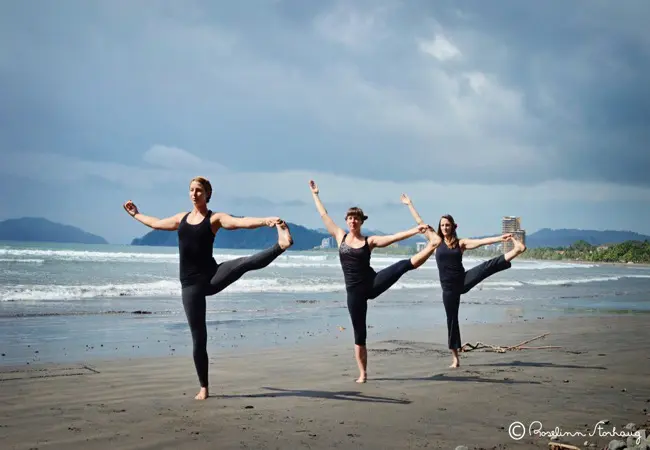 women doing padattosana at a beach