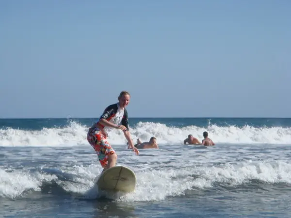 woman surfing on a tropicaal sea beach