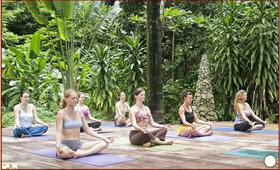 women practicing yoga at a wooden deck