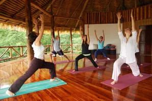 Participants are practicing Warrior pose