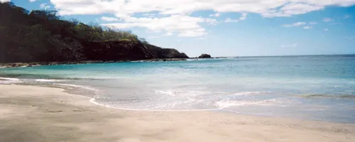 a beautiful sea beach with clean sand and crystal clear water