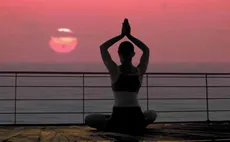 woman doing yoga during sunset