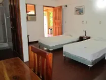 small room with double bed and attached bath