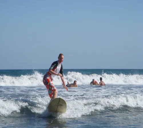woman surfing on tropical sea beach