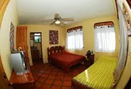 beautifully decoragted room with 2 single bed, fan and large windows