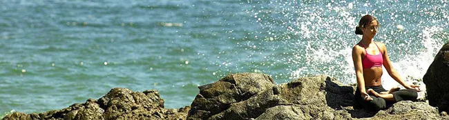 woman meditating beside sea beach