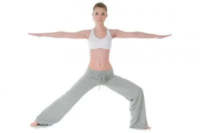 woman practicing warrior pose