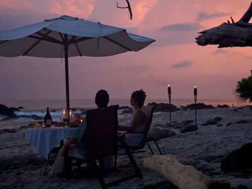 couple enjoying sunset on tropical sea beach