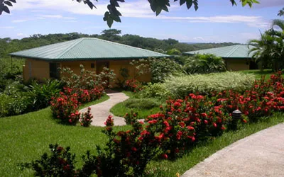 small cabina midst a garden with red flowers