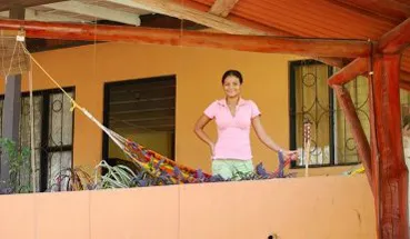 woman standing on the front door of CRSI Student Apartments