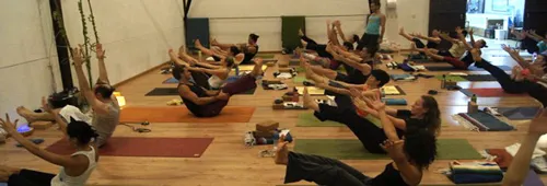 a group of people doing boat pose