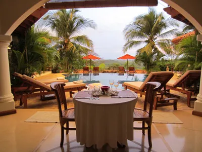 Couple's dining table beside a swimmimg pool