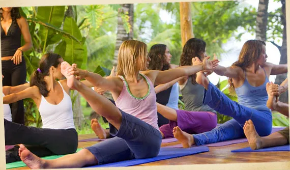 woman practicing yoga at open yoga deck