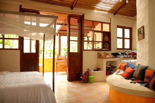 Bed room with kitchen and king size bed at Rio Chirripo Yoga Retreat Rooms