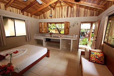Guest room with two single beds, large window and side table