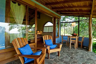 a large balcony with wooden chairs
