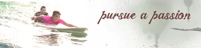 Couple surfing at a tropical waves