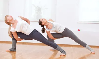 Women practicing vinyasa yoga