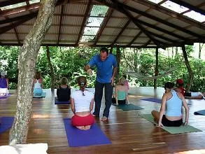 group of people practicing yoga with instructor