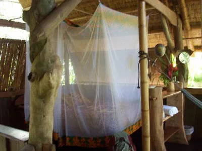 bed with mosquito net at ojo del mar