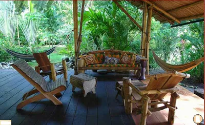wooden deck with hammock and chairs