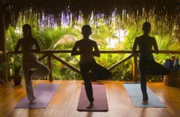 women doing yoga on a wooden deck
